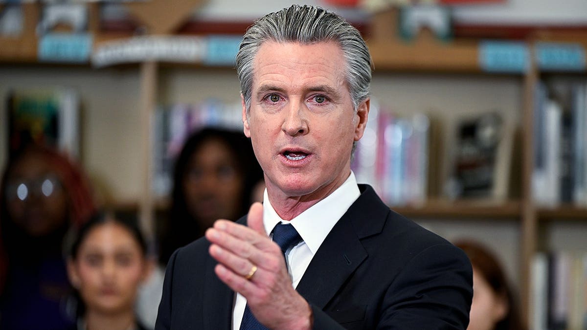 Governor Gavin Newsom speaking at a press conference at San Lorenzo High School