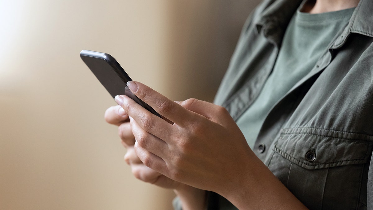 A person holds their smartphone.