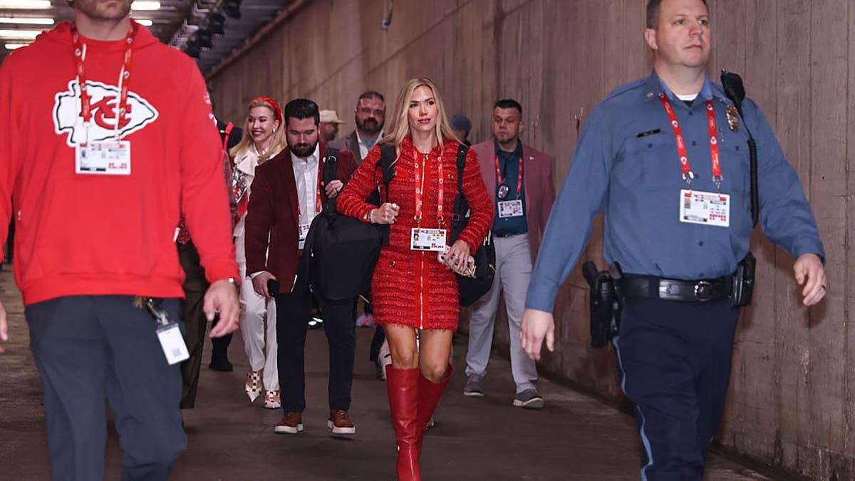 Gracie Hunt escorted by security into stadium at GEHA Field at Arrowhead Stadium