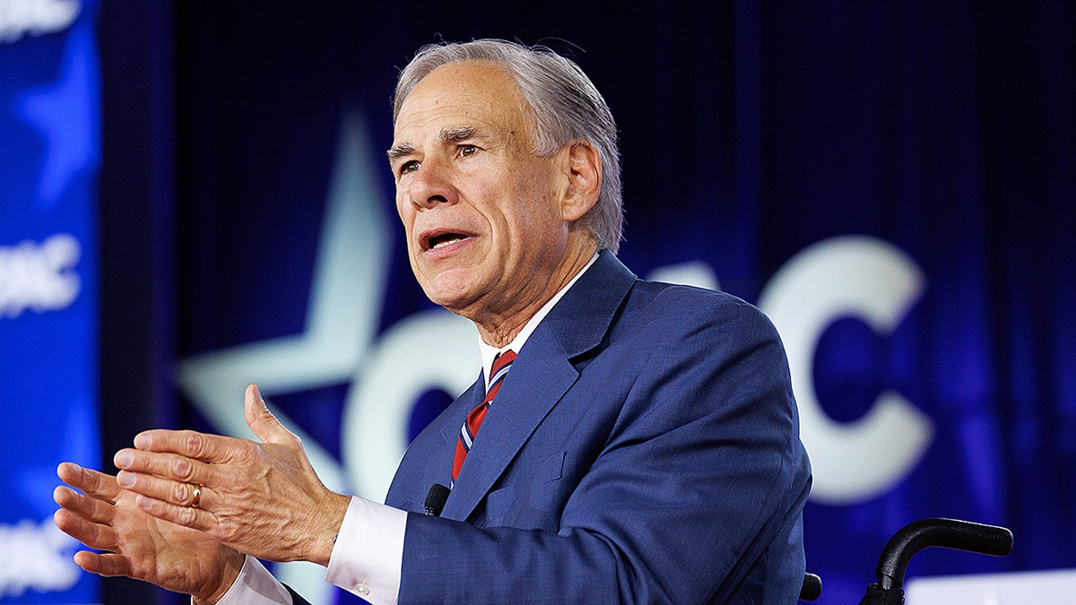 Greg Abbott speaking at a lectern during CPAC in Grapevine, Texas