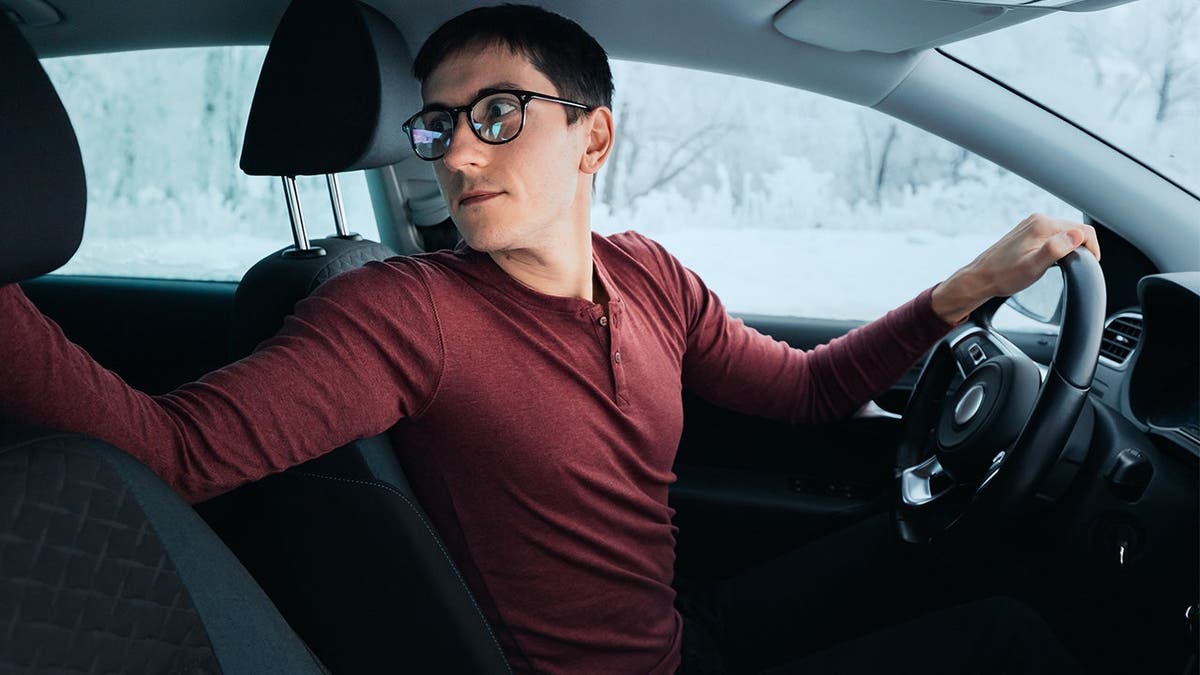 Guy backing up his car