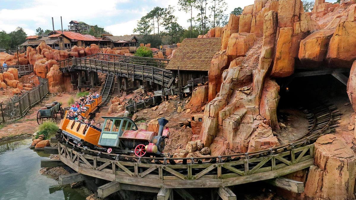 Guests riding Big Thunder Mountain Railroad at Magic Kingdom
