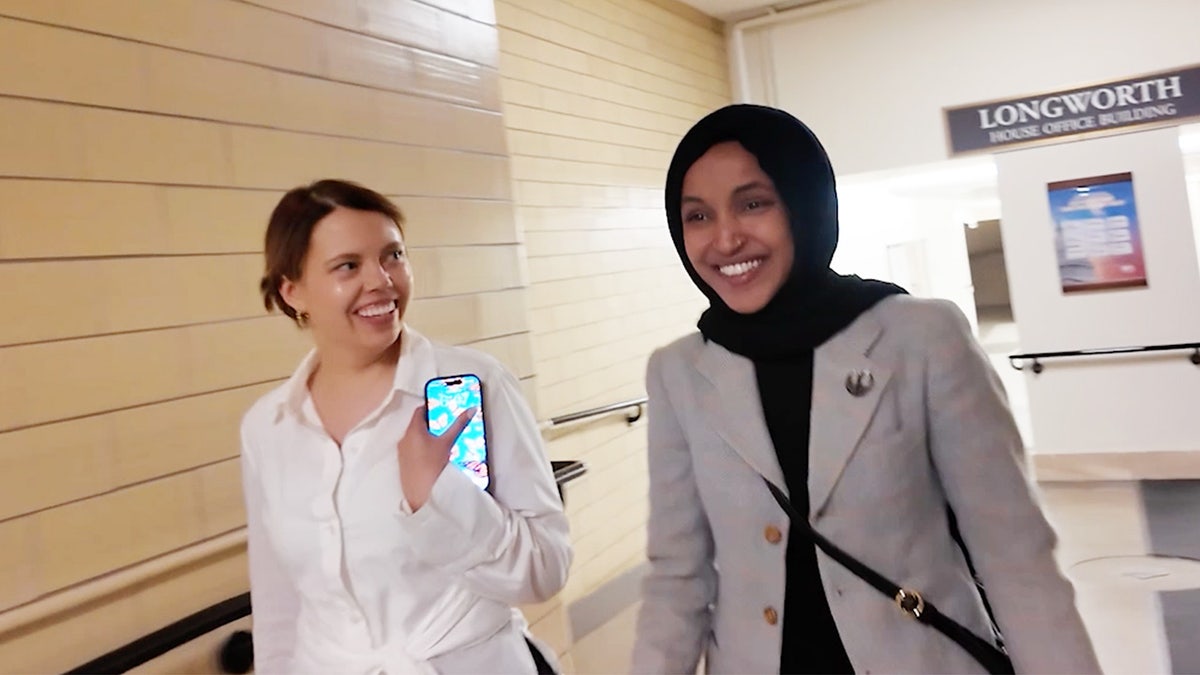 Ilhan Omar, pictured walking and talking in the U.S. Capitol basement.