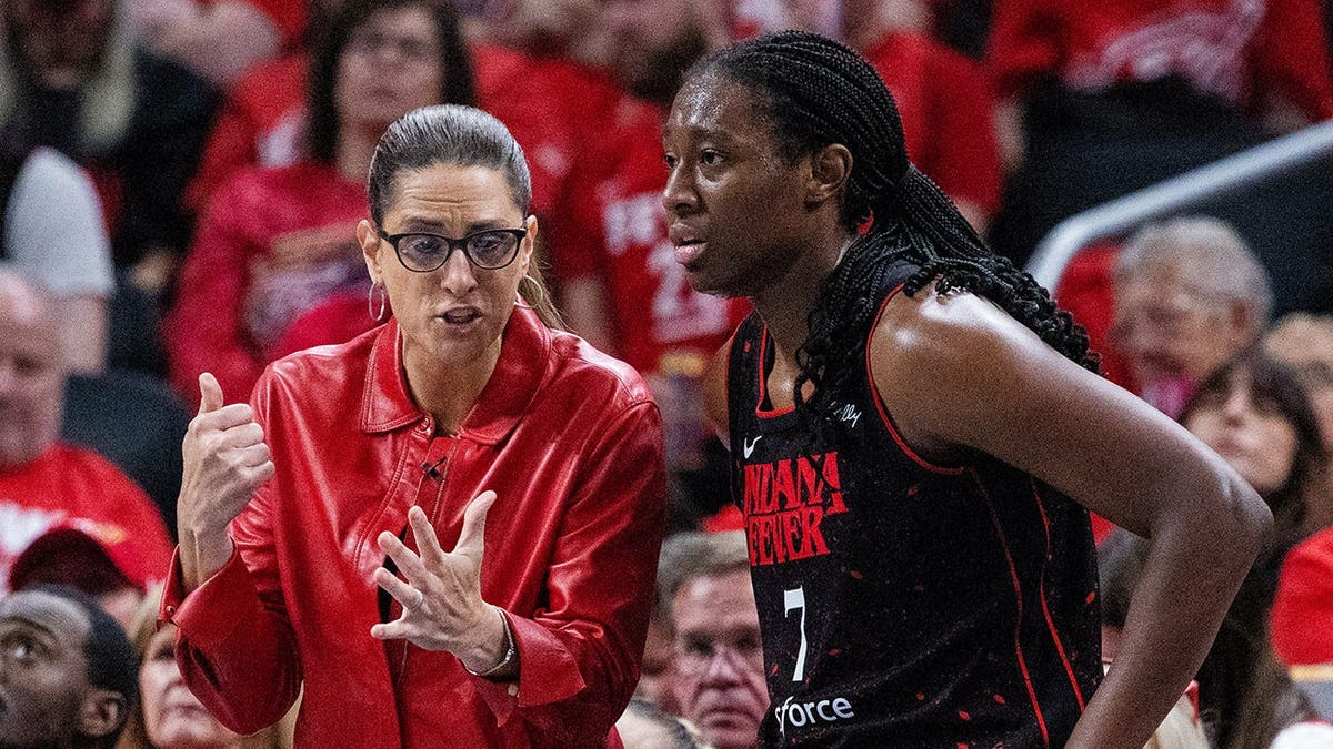 Indiana Fever head coach Stephanie White and forward Aliyah Boston playing basketball at Gainbridge Fieldhouse