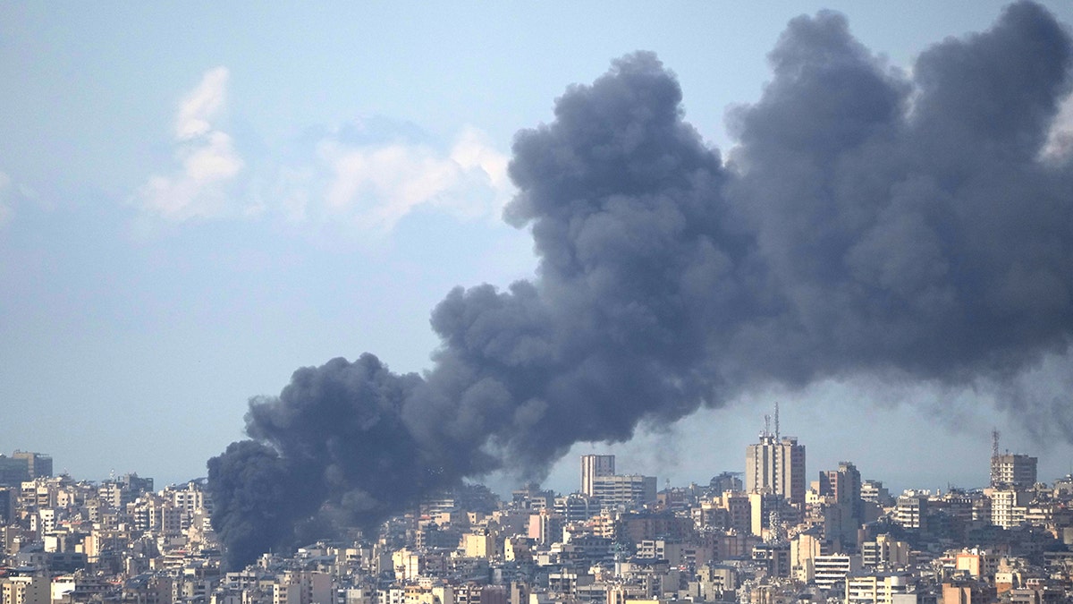 Thick black smoke rising from a building in Beirut following an airstrike.