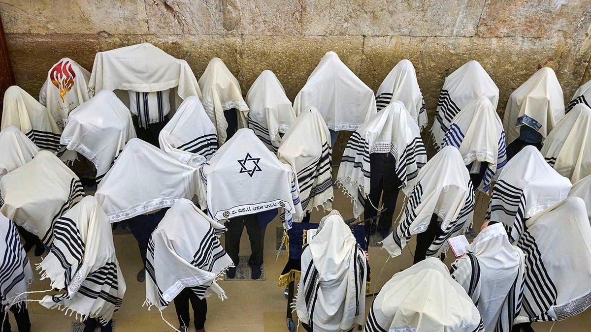 Ultra-Orthodox Jewish men praying during the priestly blessing at the Western Wall.