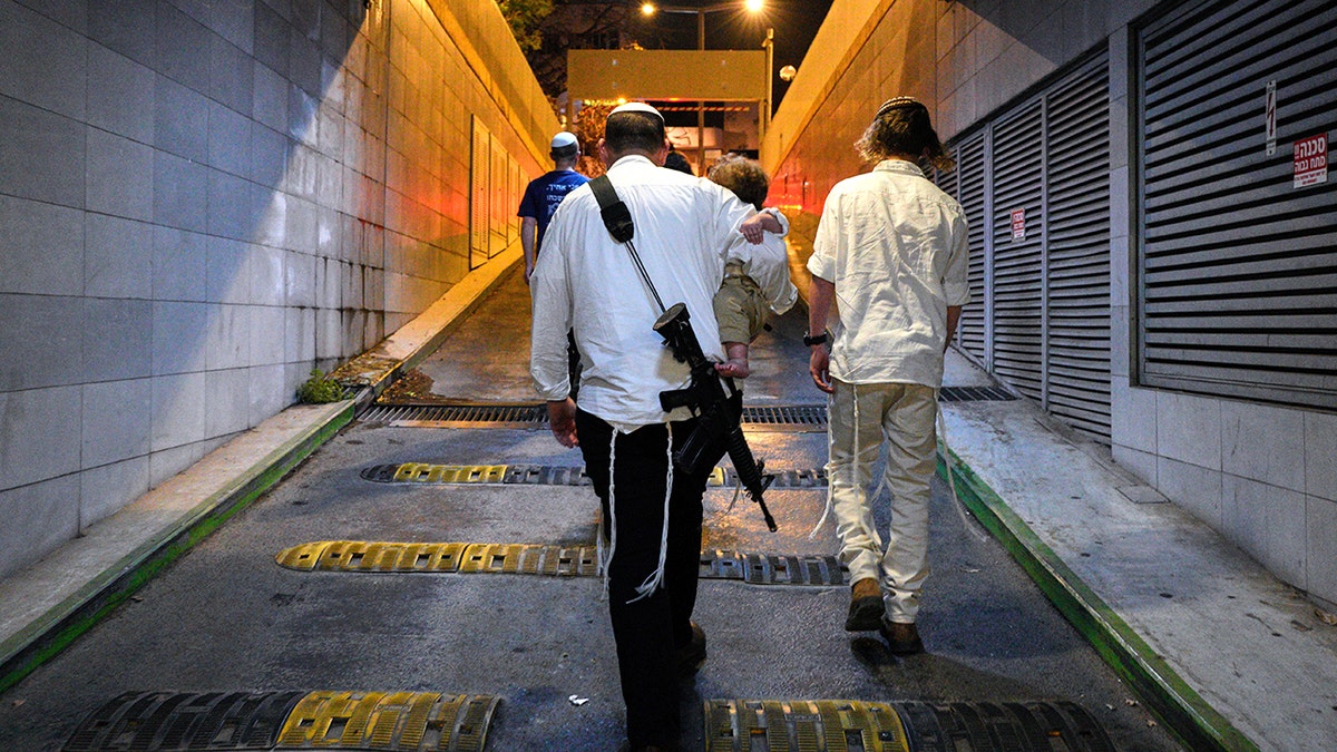 People taking cover in an underground parking garage.