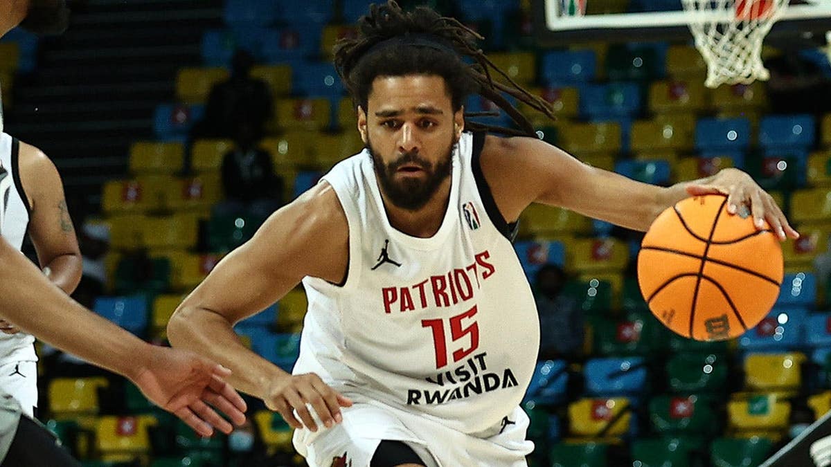 Jermaine Cole dribbling basketball during game at Kigali Arena