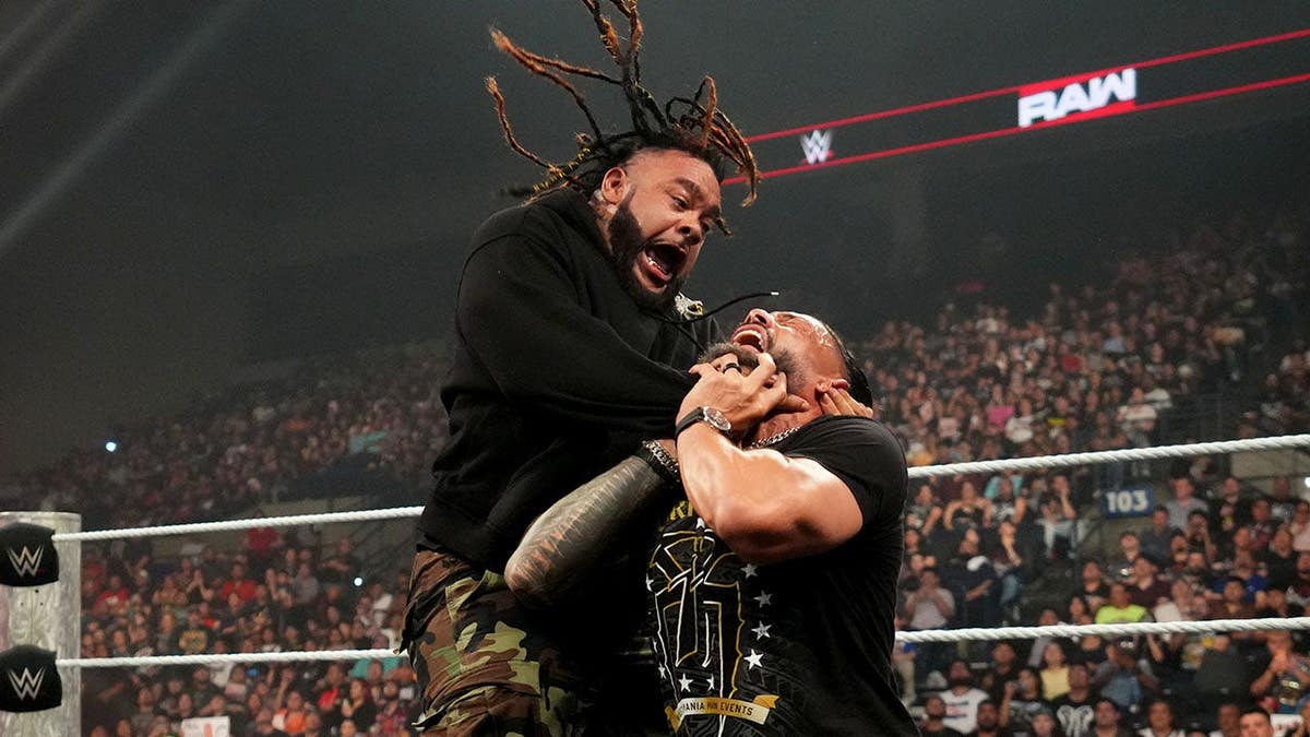 Jacob Fatu wrestling Roman Reigns in a WWE match at Sames Auto Arena in Laredo, Texas