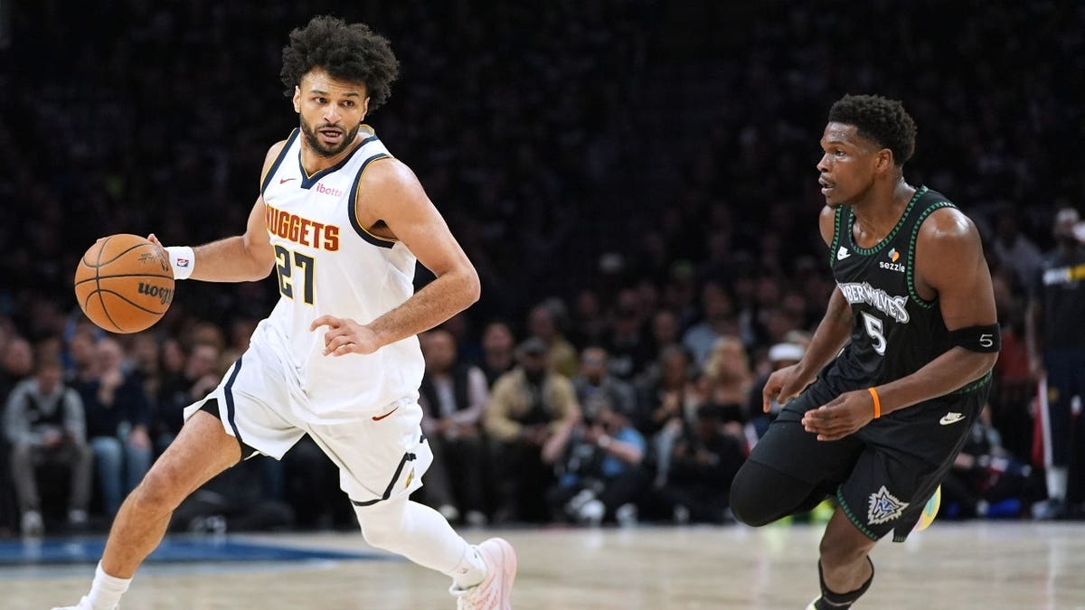 Denver Nuggets PG Jamal Murray drives to the paint on Minnesota Timberwolves SG Anthony Edwards in Game 3 in the first round of the 2026 Western Conference Playoffs.