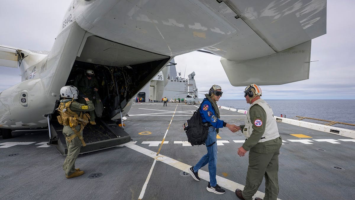 NASA Administrator Jared Isaacman greeted by Capt. Erik Kenny on USS John P. Murtha in Pacific Ocean