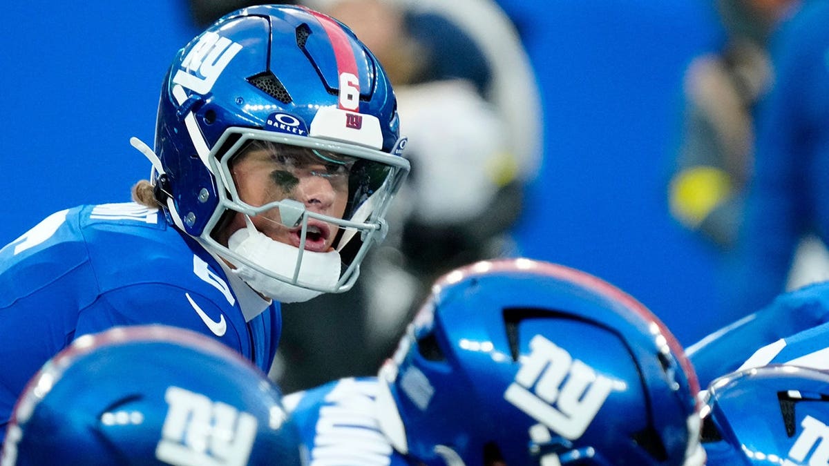 New York Giants quarterback Jaxson Dart throwing a pass during a game.