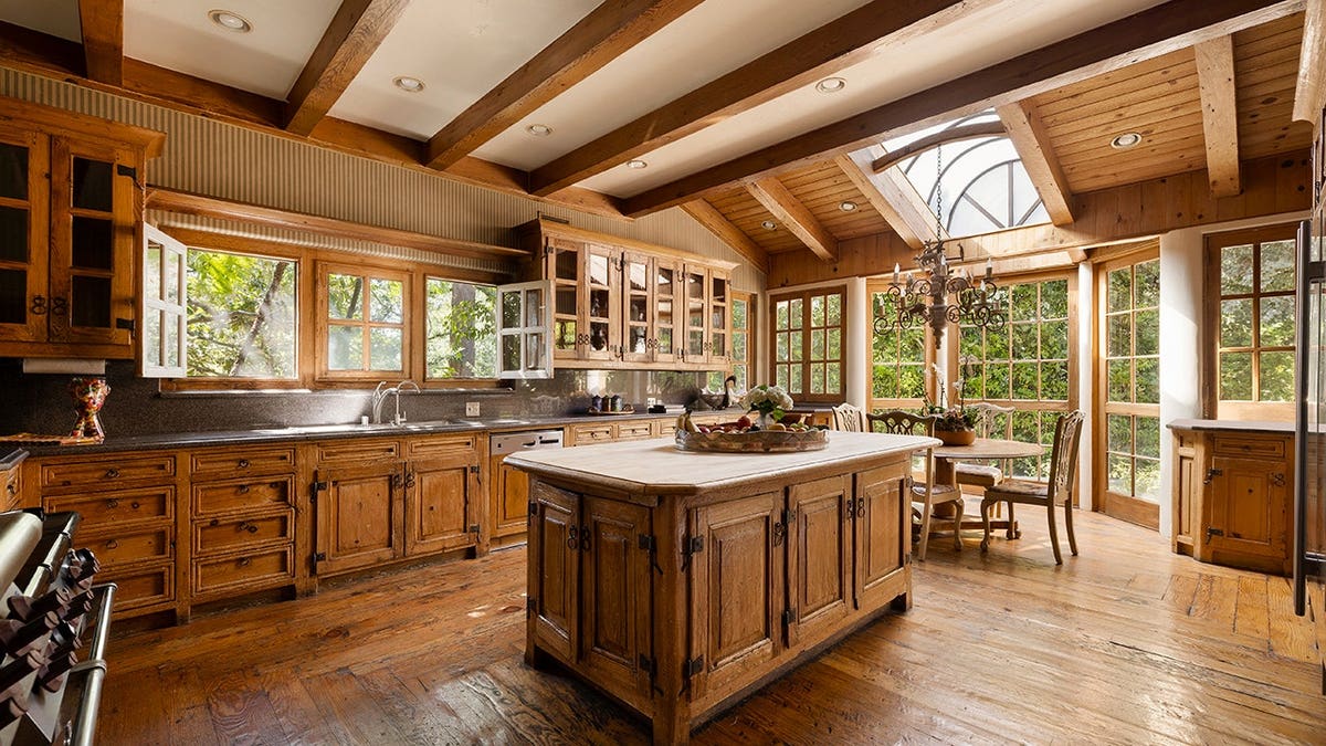 A kitchen with a center island and wooden cabinets