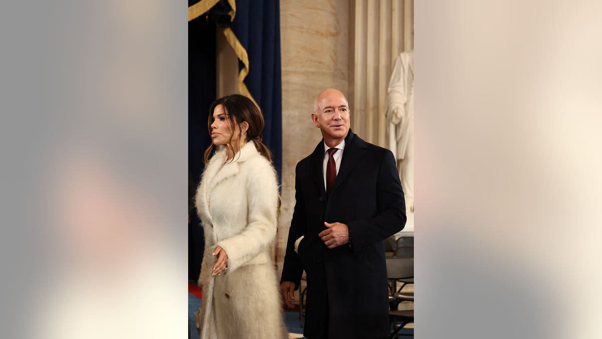 Jeff Bezos and Lauren Sanchez walking in the Rotunda of the U.S. Capitol