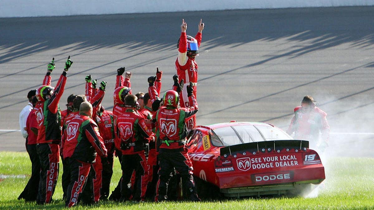 Jeremy Mayfield celebrating in his #19 Evernham Motorsports Dodge car at Michigan International Speedway