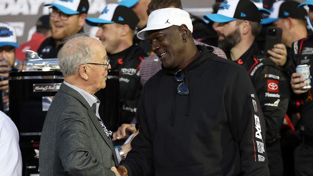 NASCAR Chairman Jim France congratulates Michael Jordan in victory lane at Daytona International Speedway