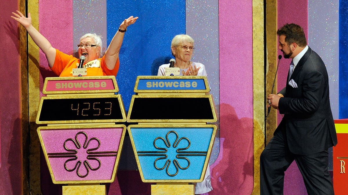 Contestant Mary Nadon celebrating winning the Showcase Showdown on The Price Is Right Live stage show with Helen Keyes and host Joey Fatone