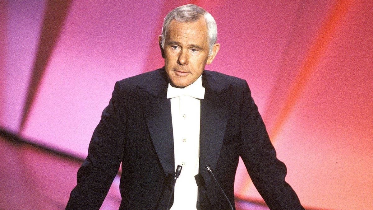 Johnny Carson hosts Academy Awards ceremony on stage.