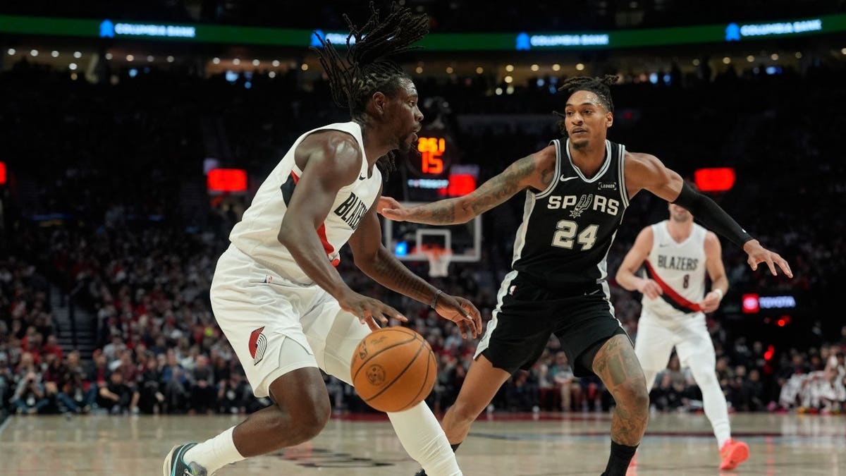 San Antonio Spurs SG Devin Vassell defends Portland Trail Blazers PG Jrue Holiday drives in Game 3 of the first round in the 2026 Western Conference Playoffs.