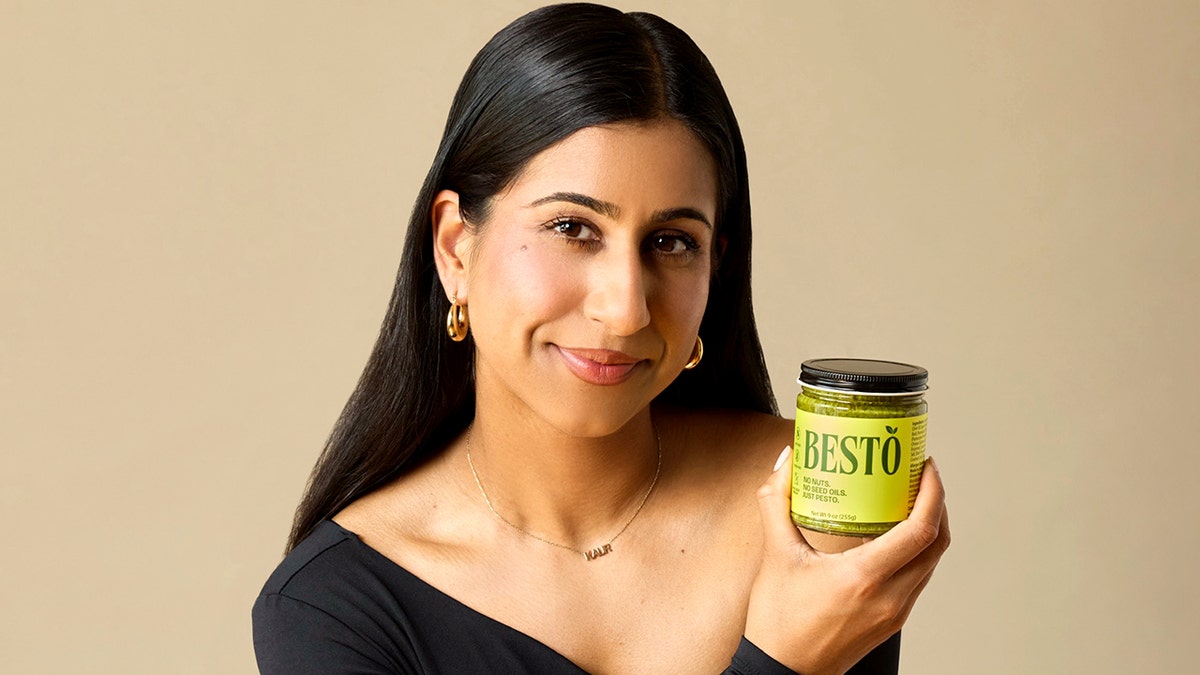 The founder of Besto holds a jar.