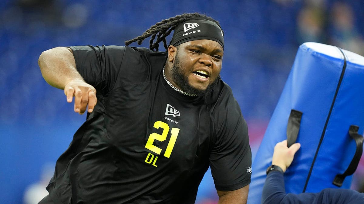Ohio State defensive lineman Kayden McDonald doing drills on the field at NFL Scouting Combine.