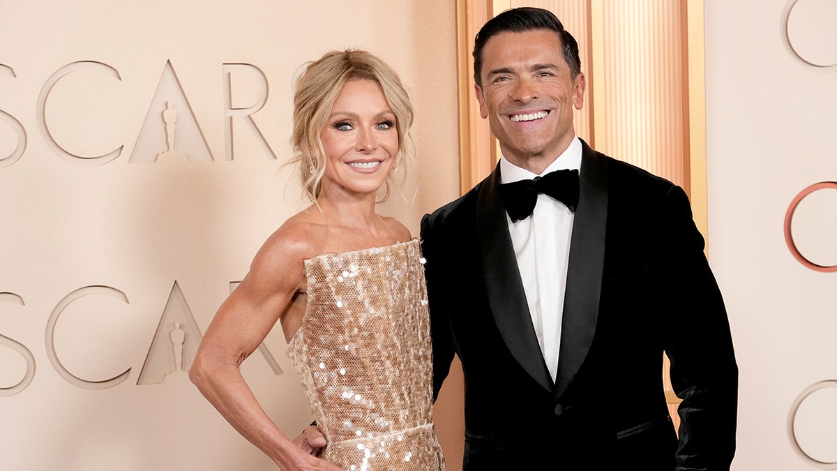 Kelly Ripa and Mark Consuelos on the red carpet at the Oscars in March 2026.