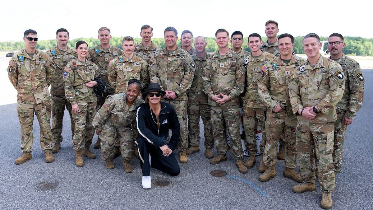 Musician Kid Rock poses for photo with troops.