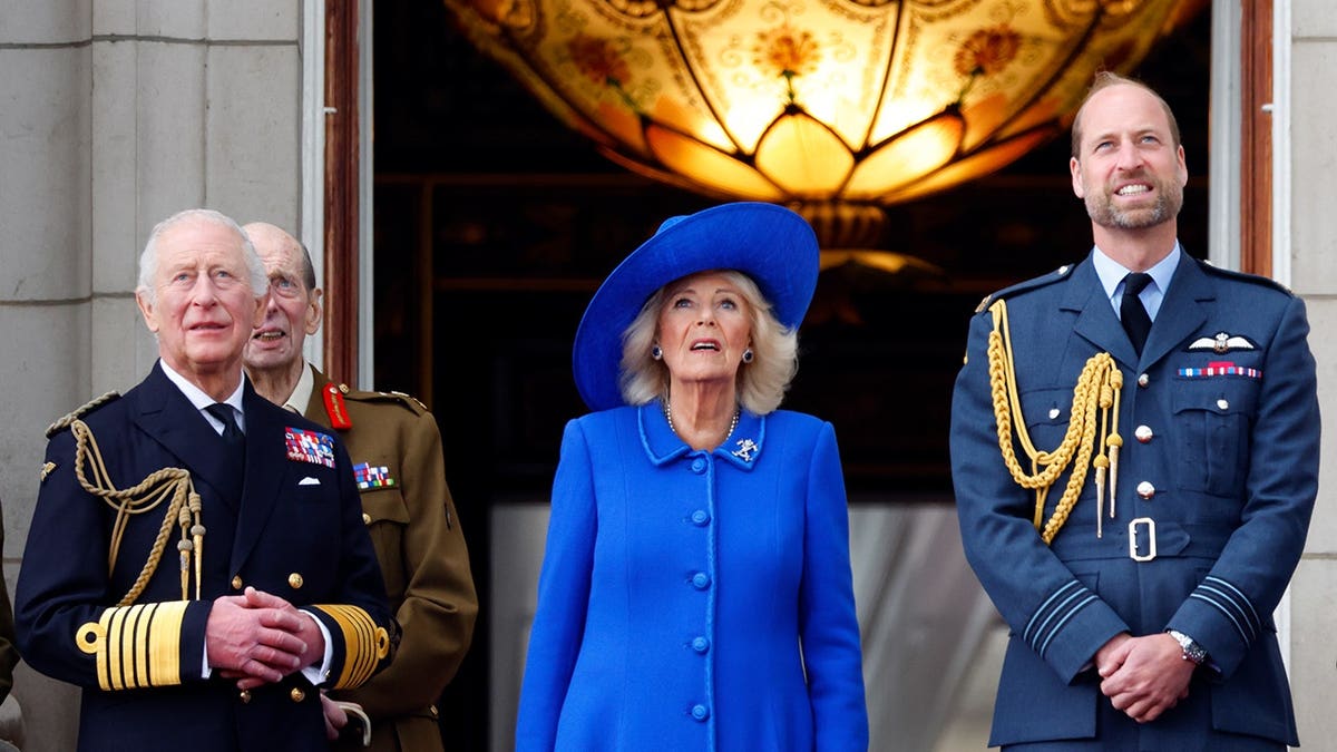 King Charles III, Queen Camilla, and Prince William watching a flypast from Buckingham Palace balcony