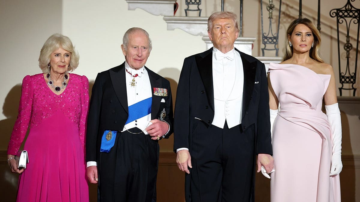 King Charles III, Queen Camilla, President Donald Trump, and First Lady Melania Trump posing on the Grand Staircase at the White House