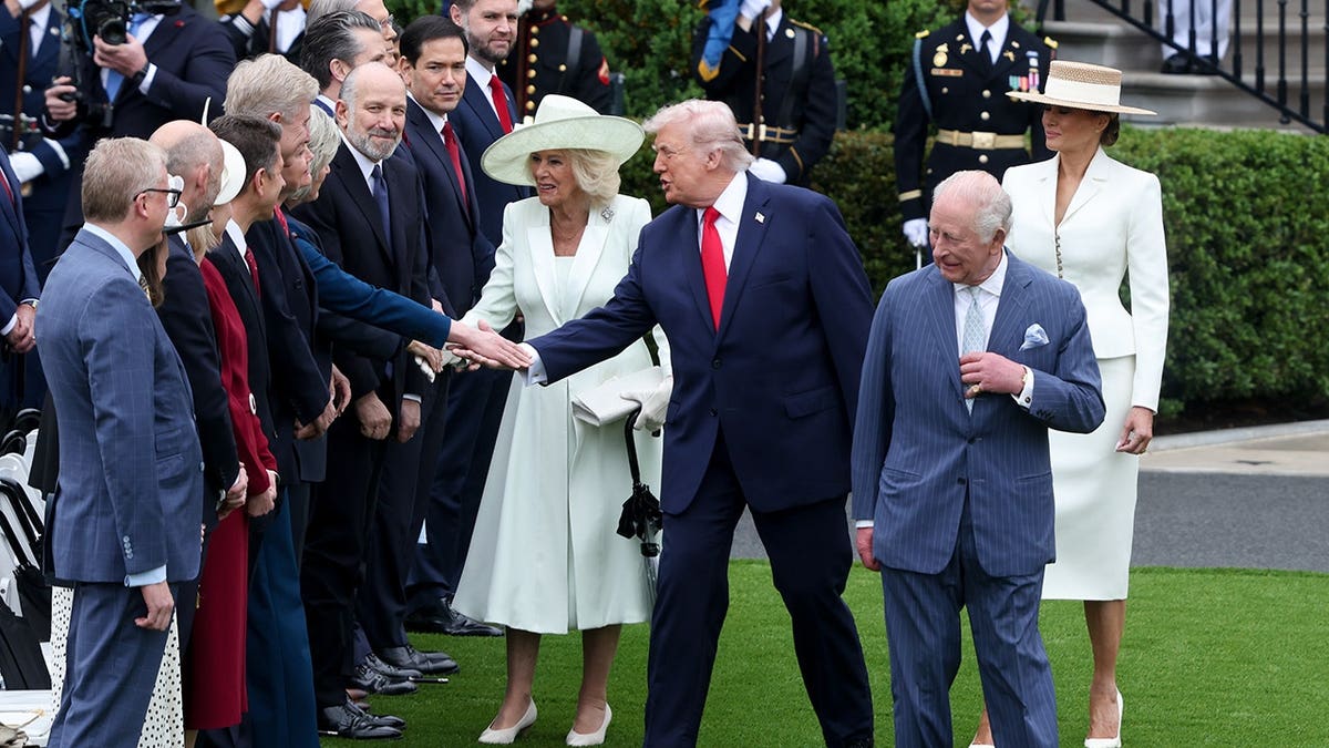 US First Lady Melania Trump and King Charles III greet officials on the White House South Lawn