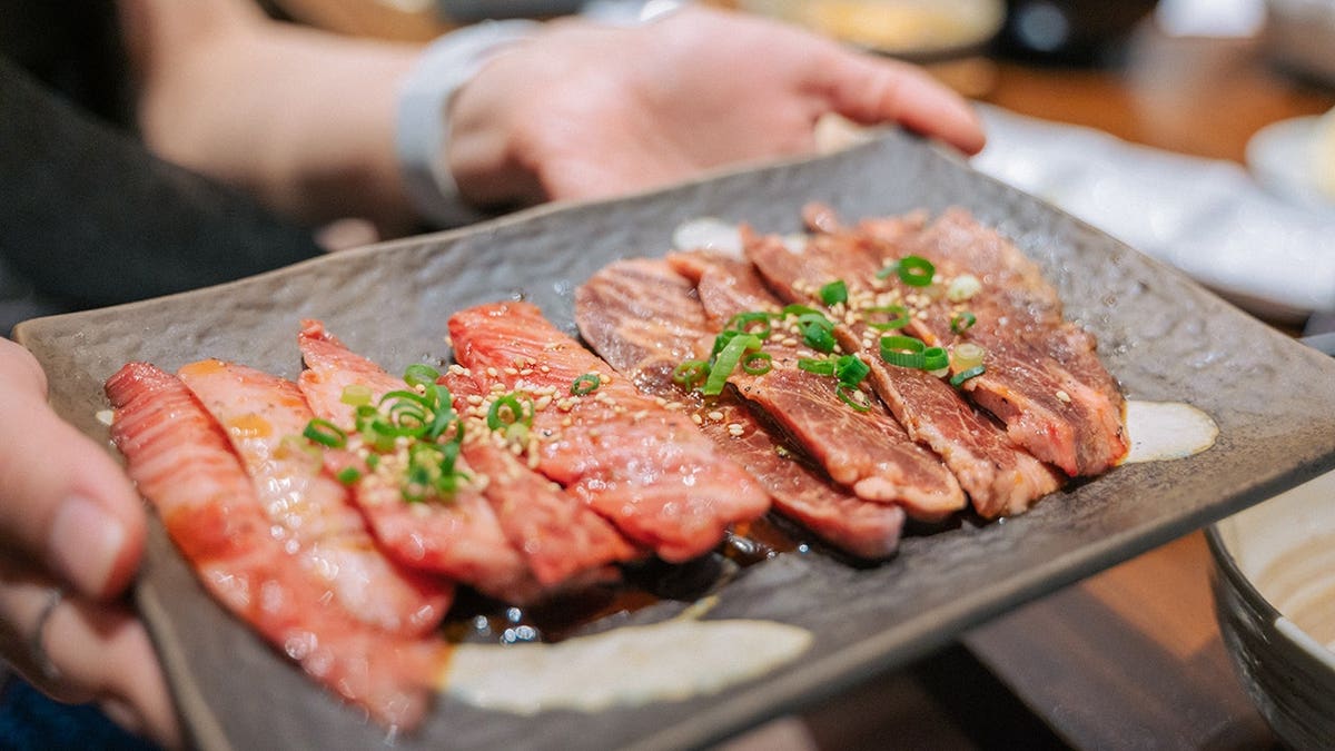Close-up of Kirabi Thai Wagyu A5 beef meal with BBQ sauce on table