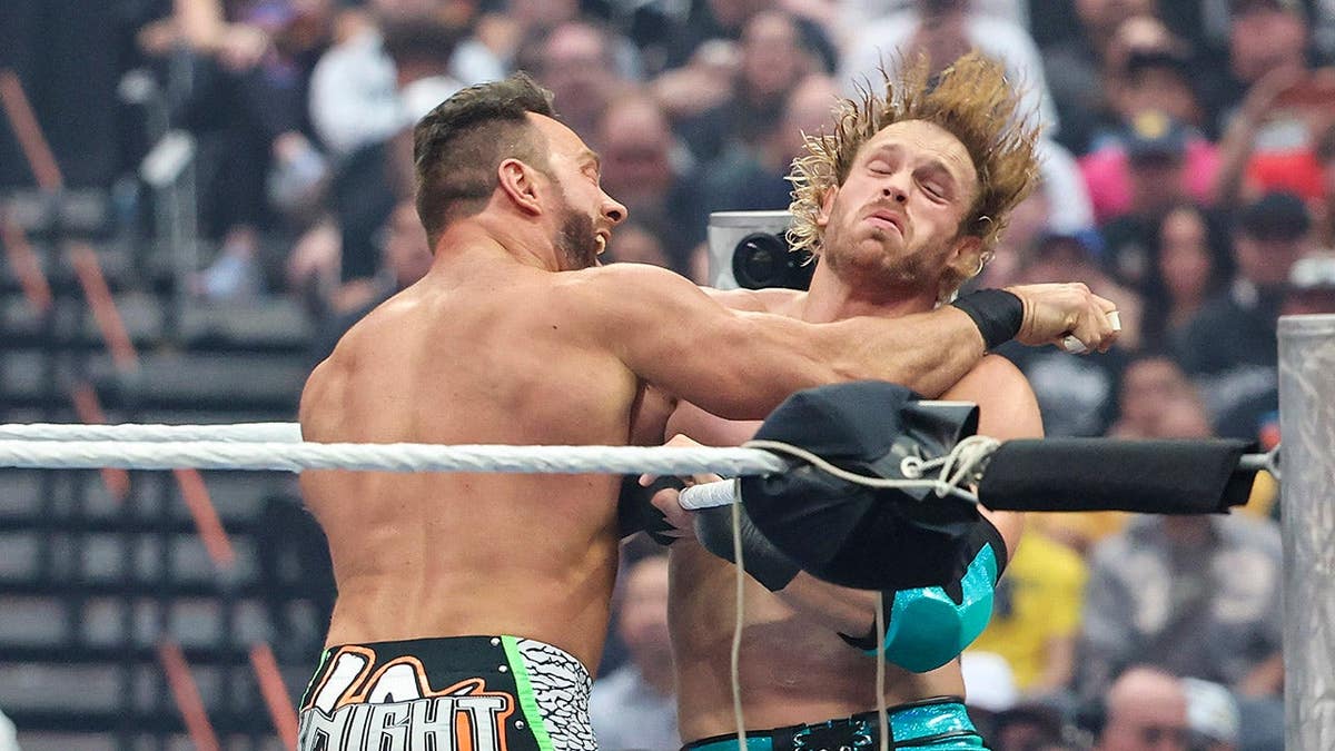 LA Knight landing a punch against Logan Paul in a wrestling match at Allegiant Stadium