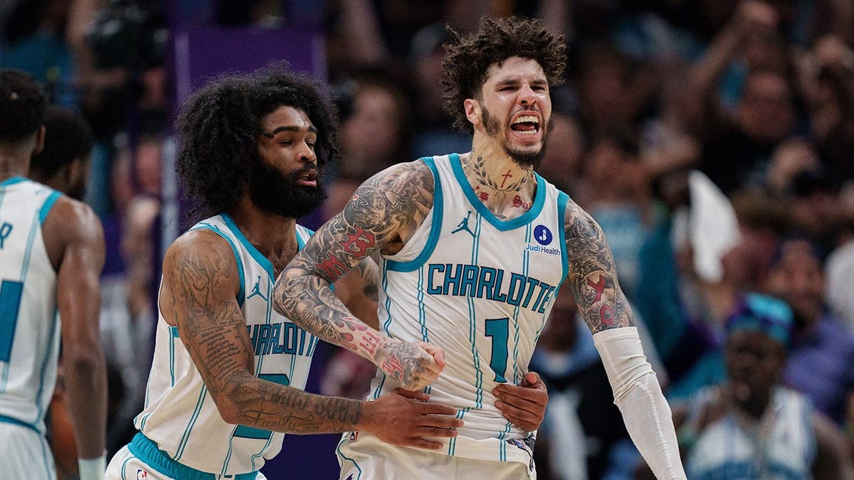 LaMelo Ball celebrating with Coby White during overtime at Spectrum Center in Charlotte