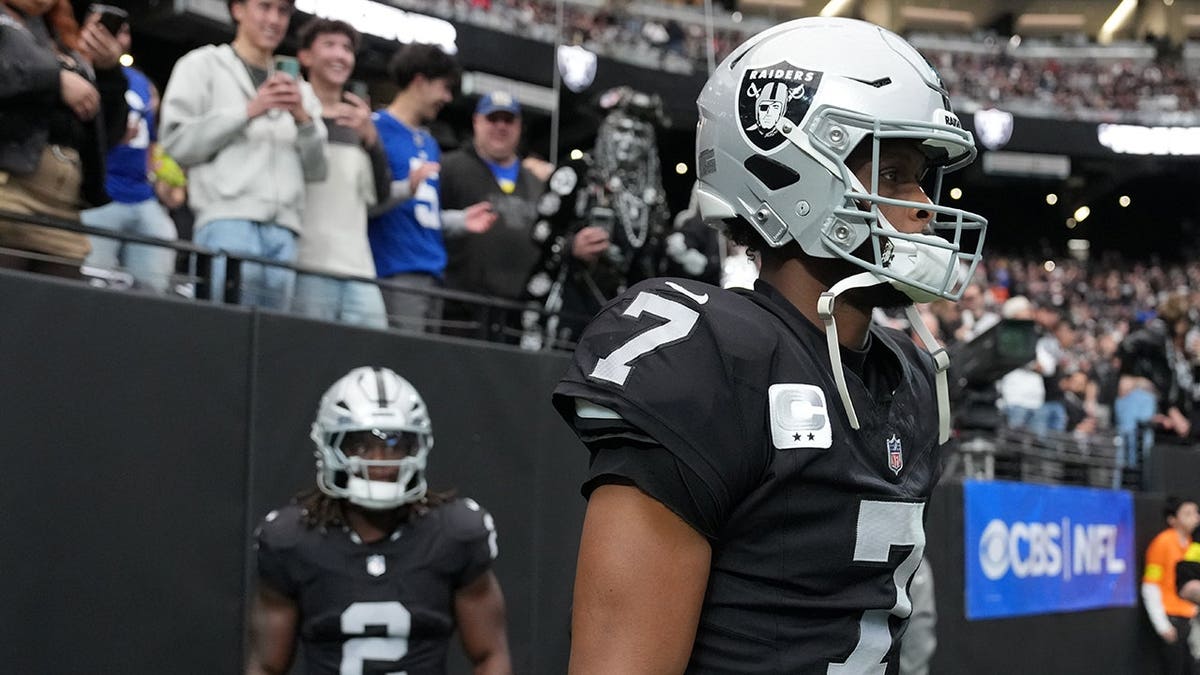 Las Vegas Raiders quarterback Geno Smith and running back Ashton Jeanty entering the field at Allegiant Stadium