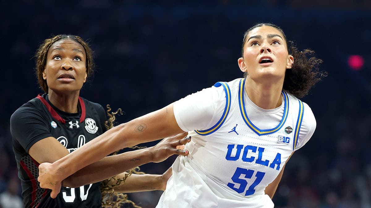 Lauren Betts and Maryam Dauda jockey for position in a basketball game.