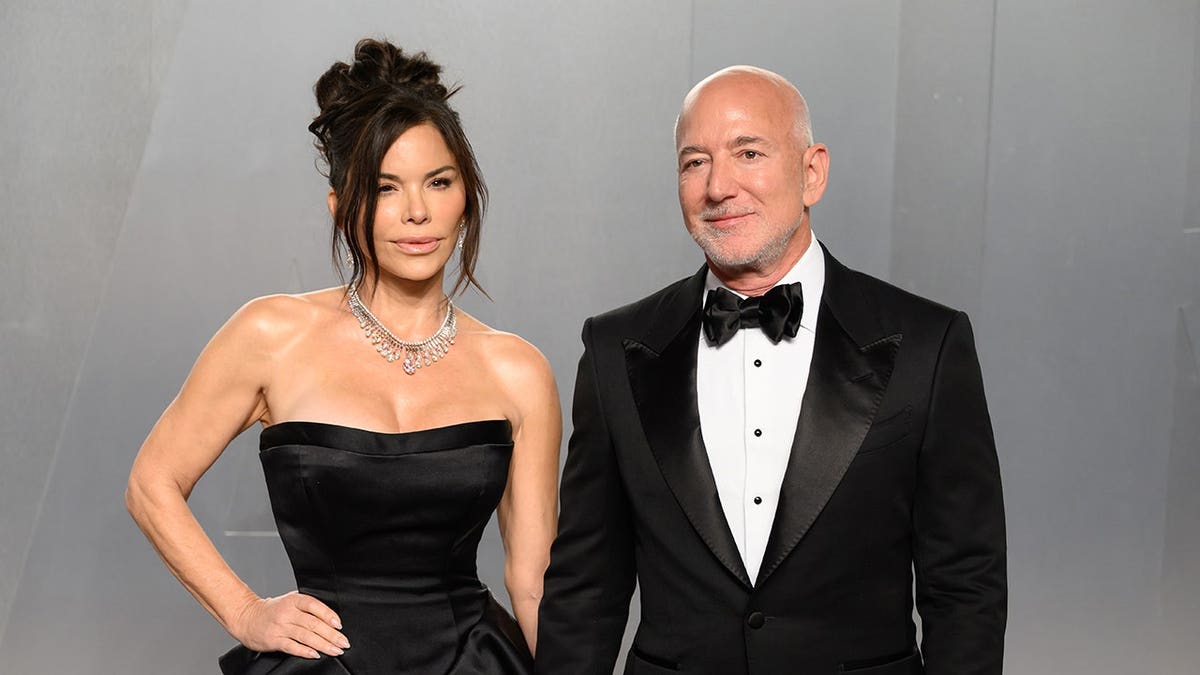 Lauren Sánchez Bezos and Jeff Bezos standing together at the Vanity Fair Oscar Party in Los Angeles