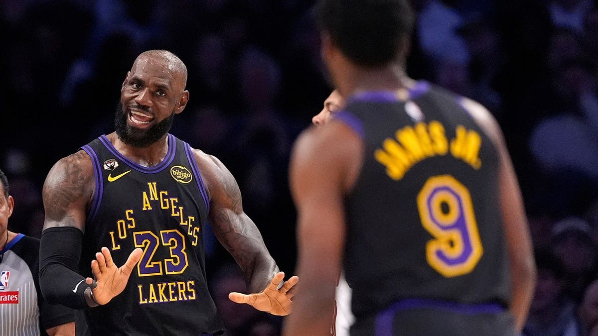 LeBron James talking to Bronny James during an NBA game in Los Angeles