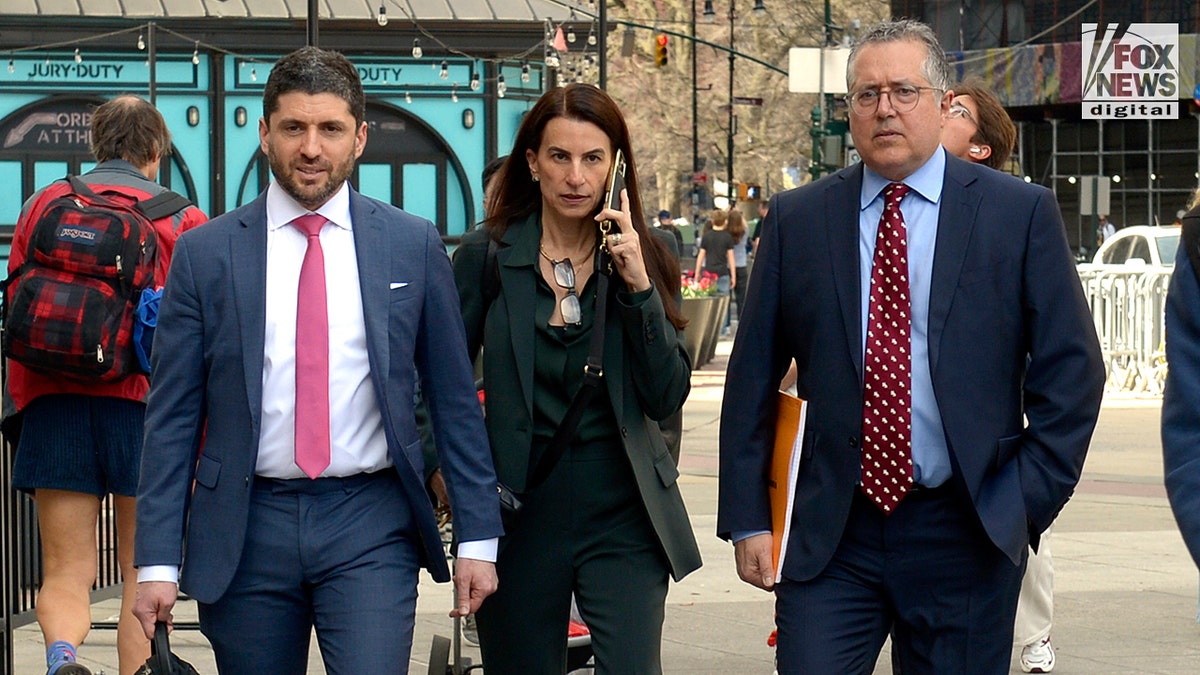 Jacob Kaplan, Karen Friedman Agnifilo, and Marc Agnifilo walking toward a court building in Manhattan.