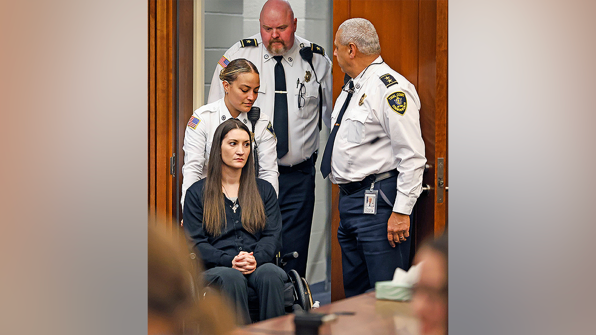 Massachusetts parent accused of sidesplitting her 3 children sits successful a wheelchair during tribunal appearance