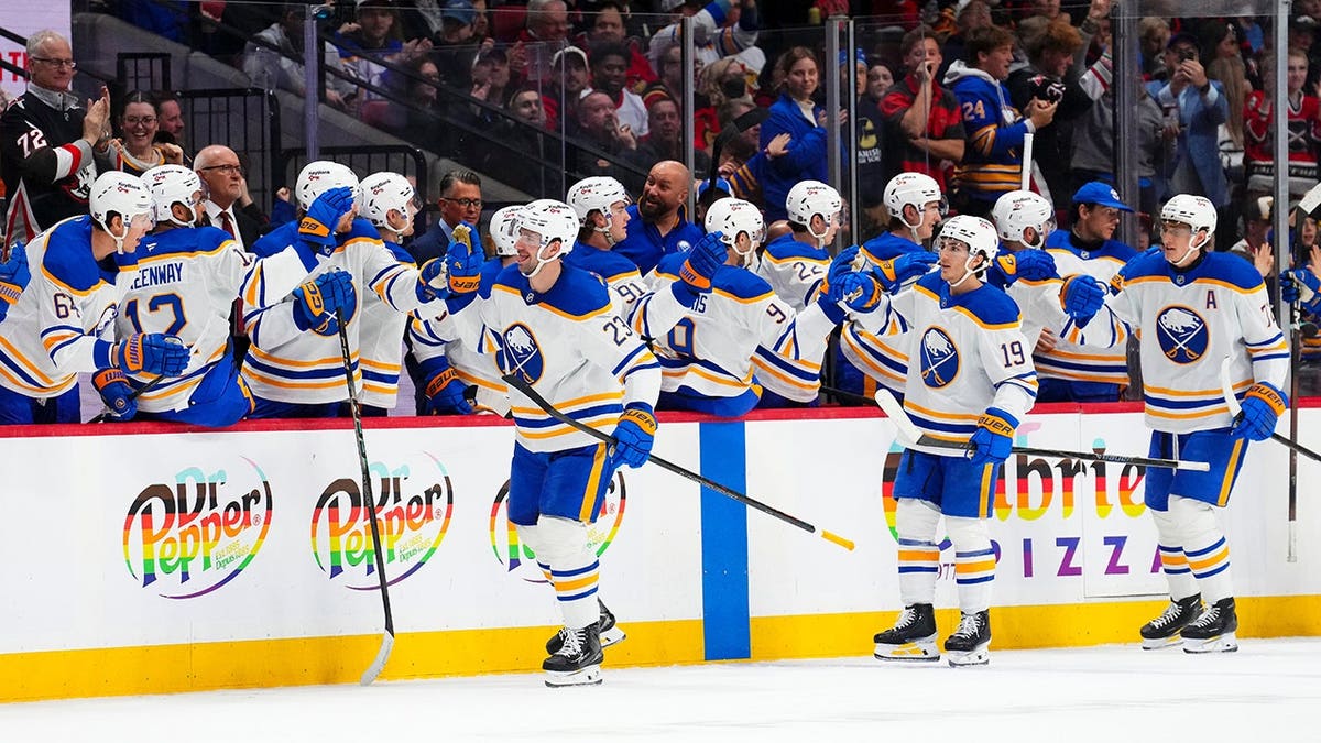 Buffalo Sabres' Mattias Samuelsson celebrating a goal with teammates on the bench during a hockey game in Ottawa
