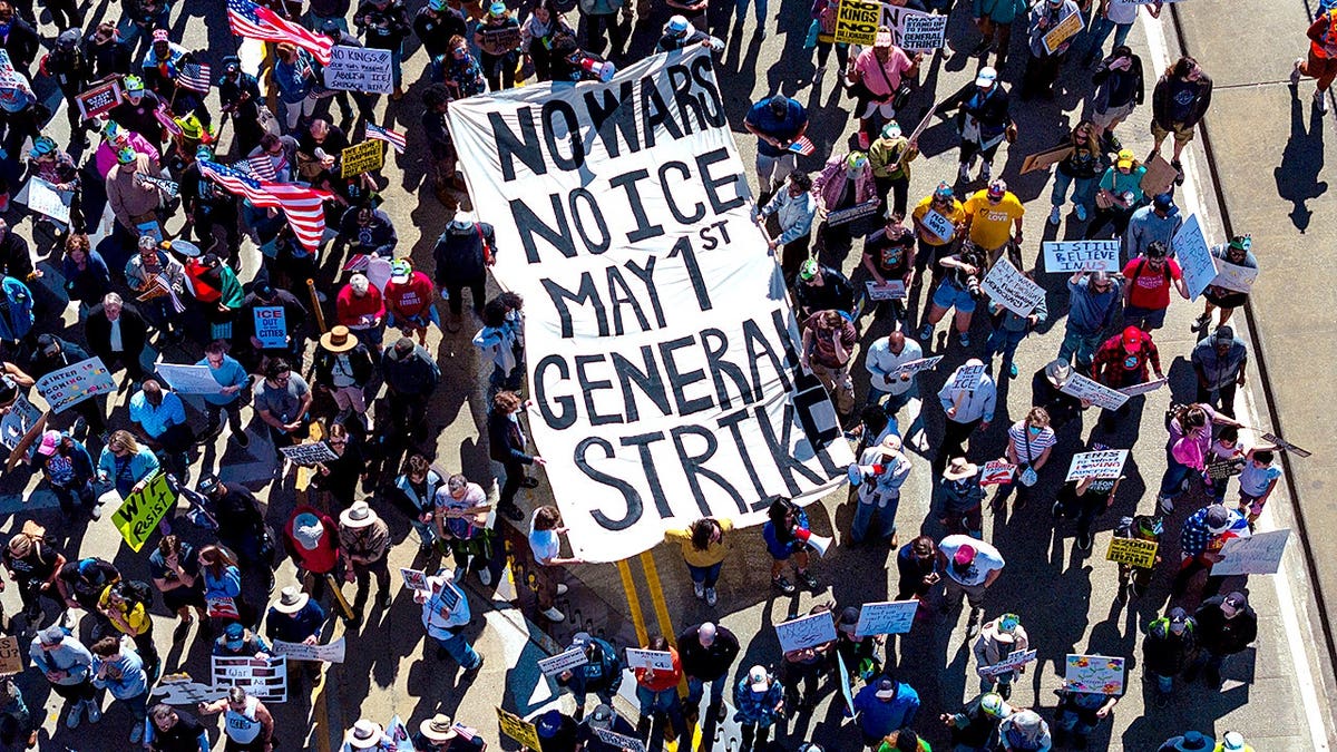 Protestors holding a May 1 strike sign