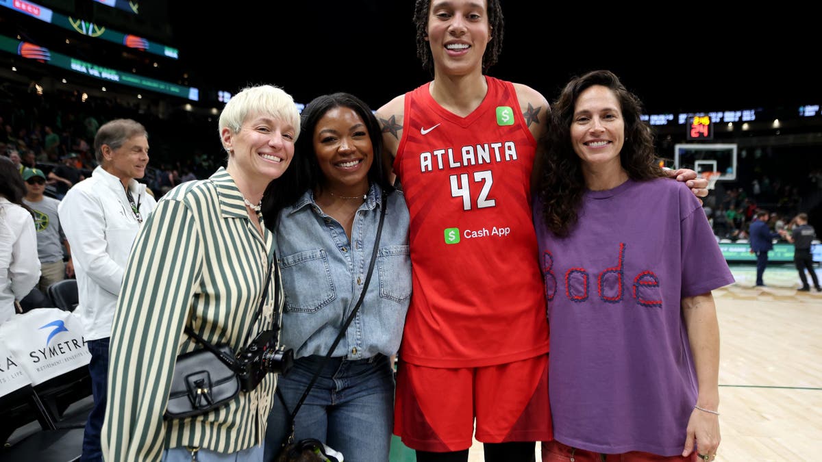 Megan Rapinoe, Brittney Griner, Cherelle Griner, and Sue Bird posing together at Climate Pledge Arena