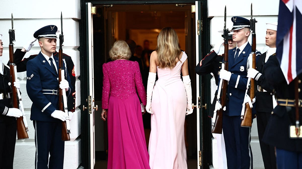 First Lady Melania Trump and Britain's Queen Camilla walking in the East Room of the White House