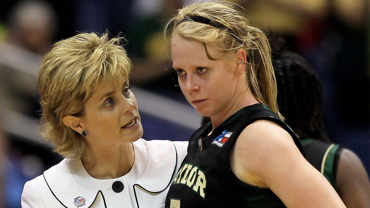 Melissa Jones of Baylor Bears being consoled by head coach Kim Mulkey at basketball game