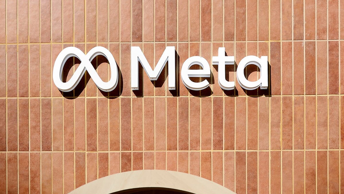 A sign on the outside of a building shows Meta branding.