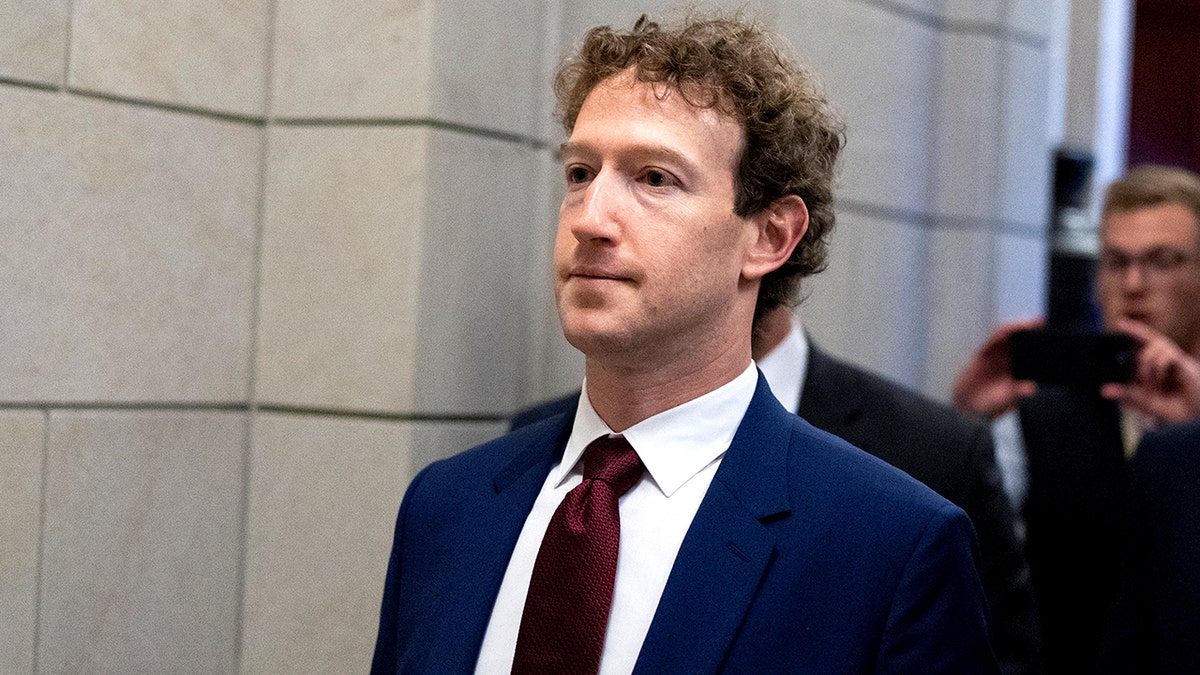 Mark Zuckerberg walks through the U.S. Capitol.