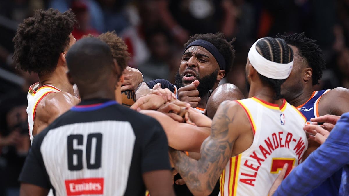 Mitchell Robinson and Jalen Johnson fighting during NBA playoff game at State Farm Arena