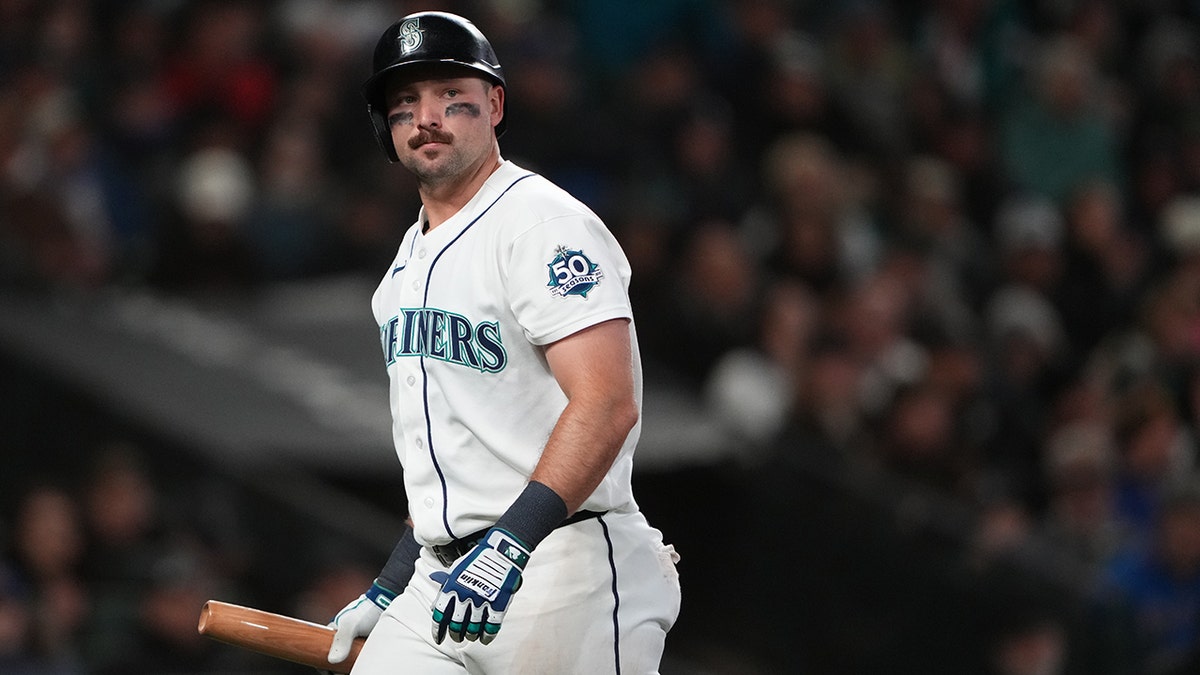 Cal Raleigh walks back to the dugout