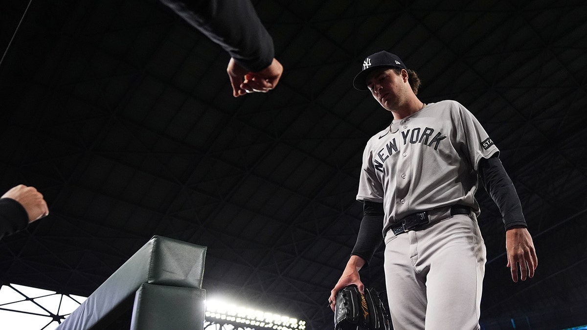 Cam Schlittler walks back to the dugout