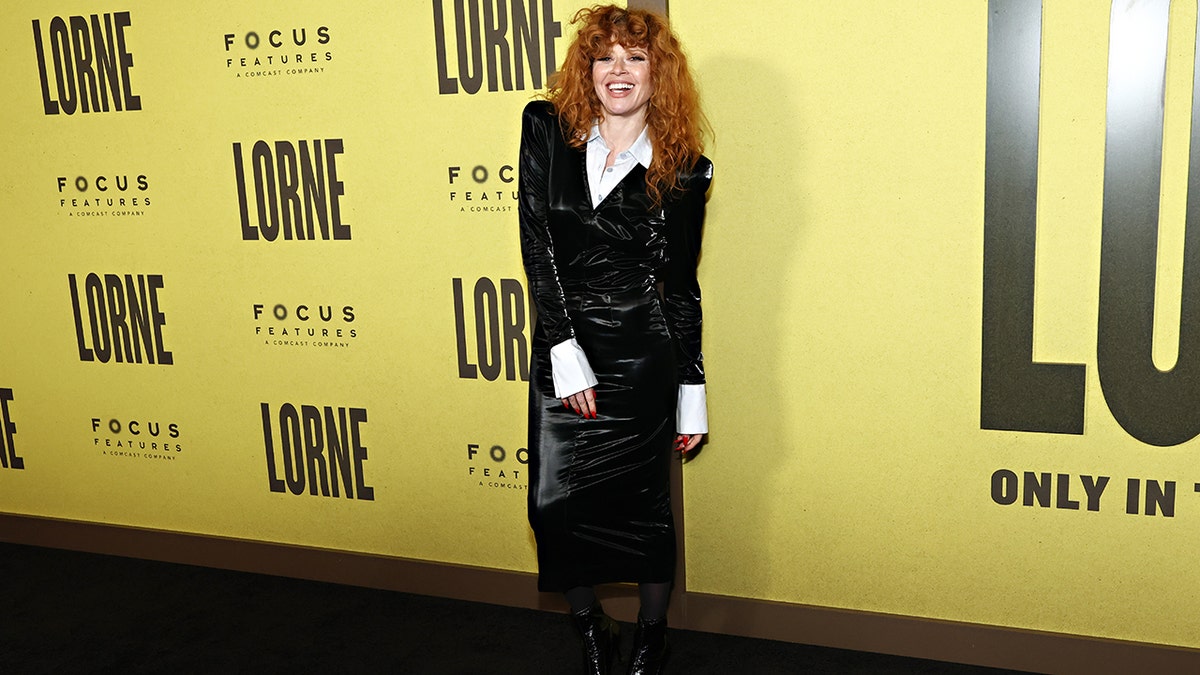 Natasha Lyonne poses on the red carpet at the premiere of "Lorne" in New York City, smiling for photographers.